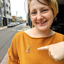 Load image into Gallery viewer, Phoebe wearing the LudoCherry pin.
